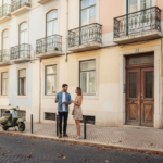 Lisbon street with real estate agent and couple