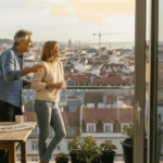 Couple on balcony overlooking Lisbon cityscape